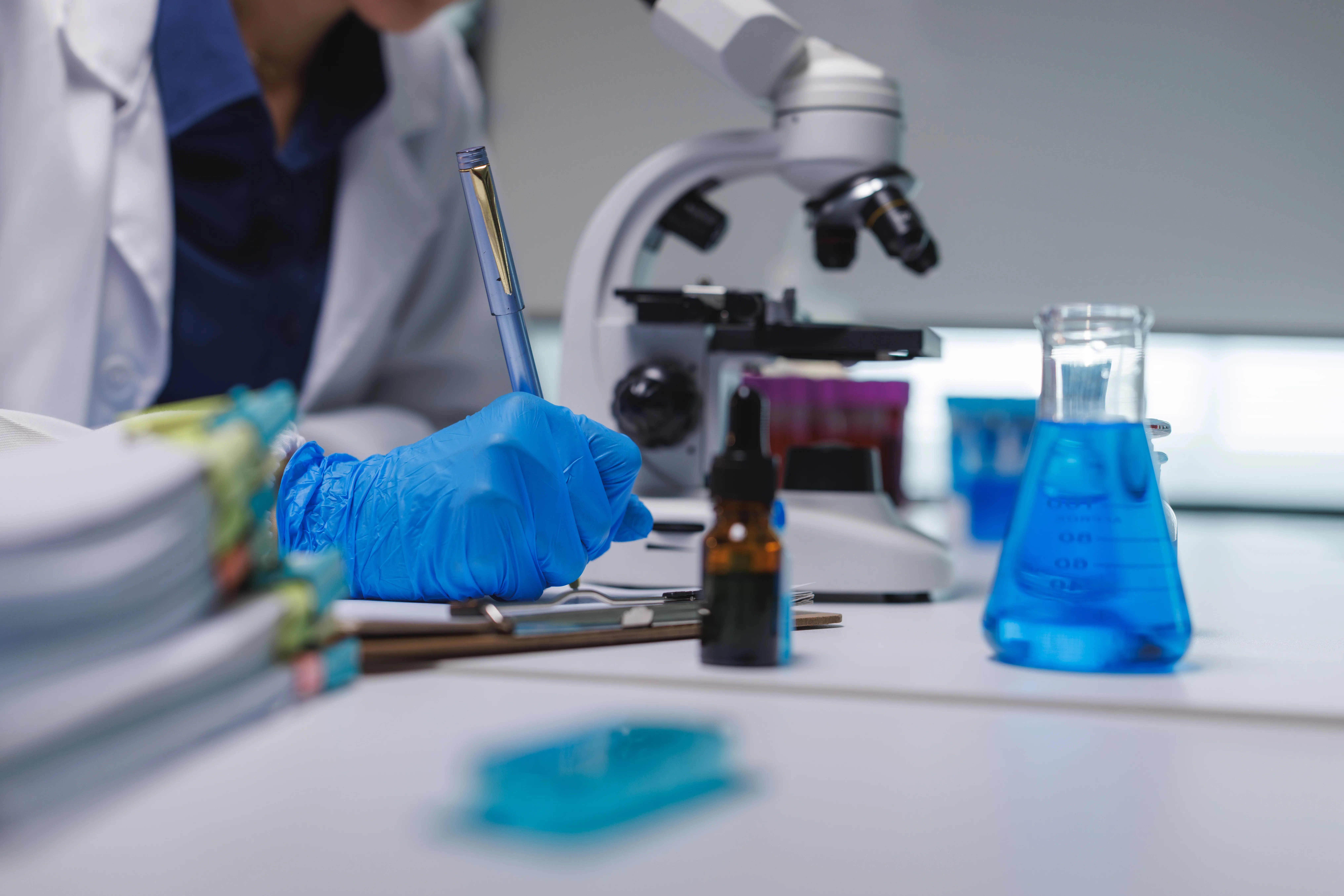Lab technician analyzing cosmetic active ingredients and formulation stability for OEM skincare contract manufacturing
