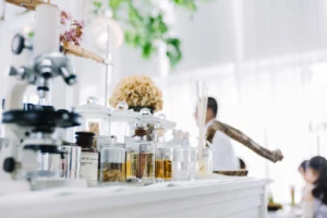 Microscope and natural extract test tubes in a laboratory, symbolizing 2027 skincare and supplement trends and cellular-level innovations.