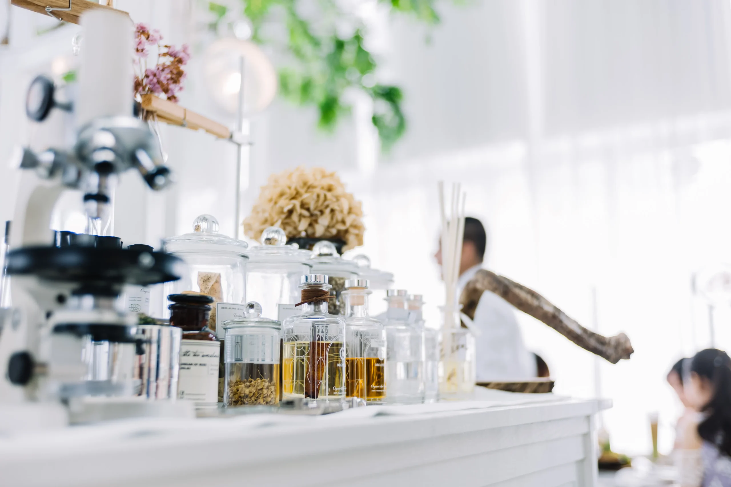 Microscope and natural extract test tubes in a laboratory, symbolizing 2027 skincare and supplement trends and cellular-level innovations.